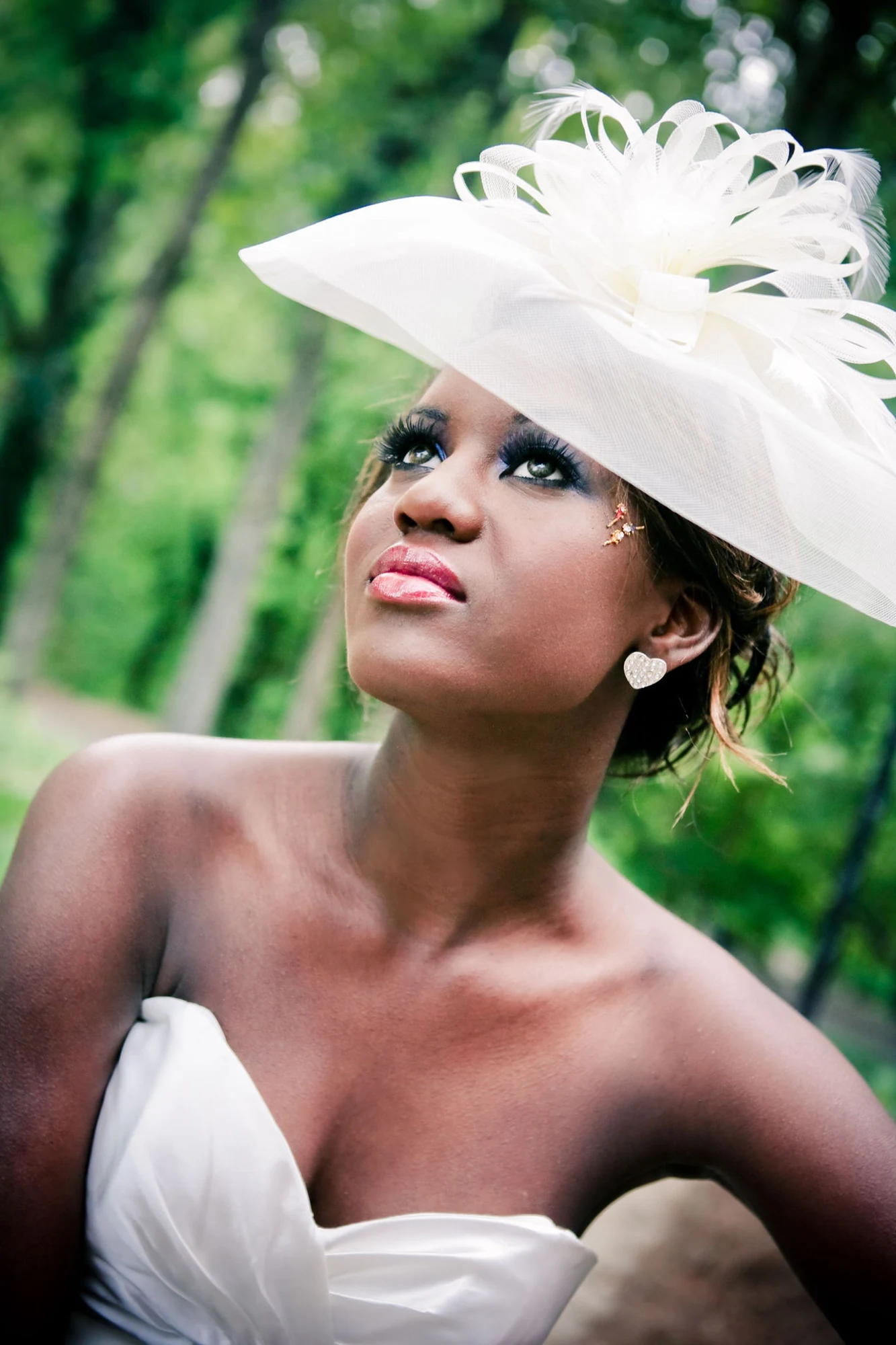 A bride in a garden wearing makeup by Rockelle