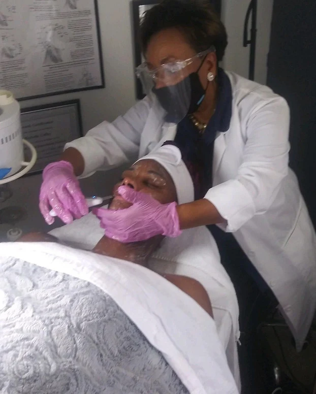 Rockelle caring for a client during a facial